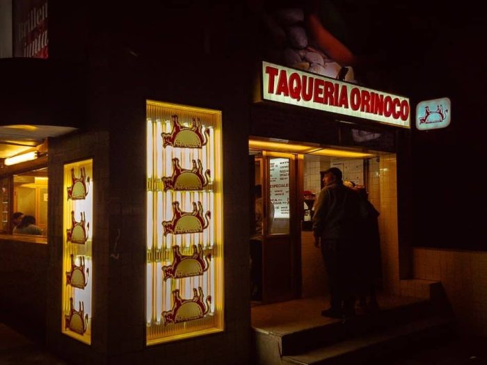 illuminated taco kiosk at night